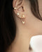 cult ear cuff layered with multiple stud earrings for dream stack inspiration