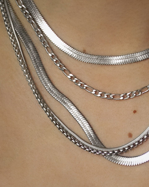 curation of silver chain necklaces with interesting and unique textures