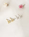 dainty fleur studs in gold and silver by jewelry label the hexad