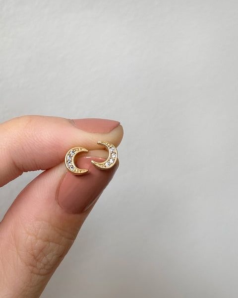 delicate crescent stud earrings embellished with diamonds