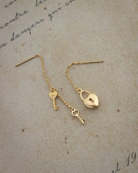 delicate drop earrings featuring heart locket and small keys from the hexad