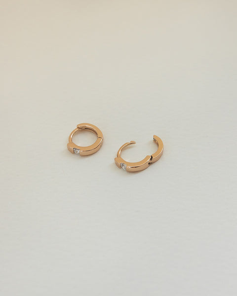 delicate iota huggie hoops in gold for a smart everyday ensemble