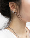 ear model wearing uki huggie hoops in silver @thehexad