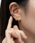 ear party with petite huggie hoops and tiny stud earrings from the hexad