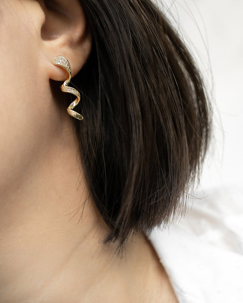 fashionable corkscrew style earring with glittery gemstones to rock a party look