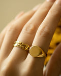 finger stack featuring classic circle signet ring and double luxor rings from the hexad