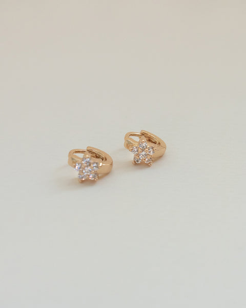 flattering huggie hoop earrings with floral star cut diamonds by the hexad