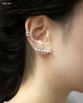 gala ear cuff worn on the right ear stacked with astraea cuff in silver