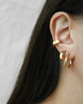 gold stack earrings with thehexad signature rei hoops and bullet cuffs
