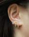 how to layer the hexad huggie hoop earrings for multiple piercings for a stylish shiny stack