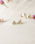 intricately designed bee and honeycomb shape stud earrings in gold by the hexad