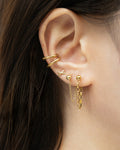 low key drop style chain earrings in gold from contemporary accessories label the hexad
