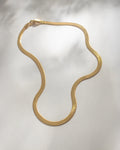 make a bold statement in the serpentine chain necklace in gold