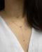minimalist y necklace for plunging low necklines by the hexad