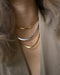 mix gold and silver necklace chains in a chic cascading stack for office and runway