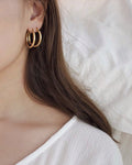 model wearing the original rei hoops in gold for a double stack effect