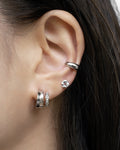 modern ear stack comprising atlantis illusion earrings, pinwheel stud and cult ear cuff in silver from the hexad