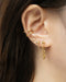 modern gold ear stack with drop chain earrings by the hexad