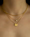 modern neck stack consisting of 1967 tag necklace, solitaire pendant necklace and the parallel chain in gold