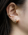 modern stylish ear party featuring atlantis illusion hoops, eve baguette stud earring and astraea double ear cuffs in gold