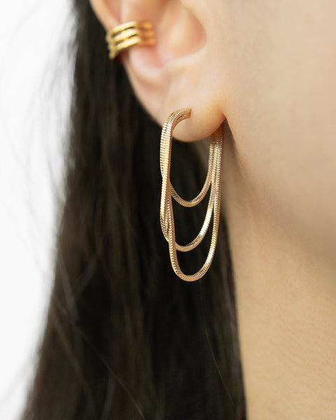 slinky drop earrings in gold by the hexad