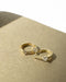 snug huggie hoop earrings in gold with tiny zirconia stones by the hexad