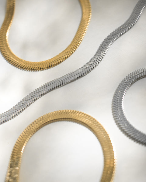 the statement cobra chain necklaces in silver and gold