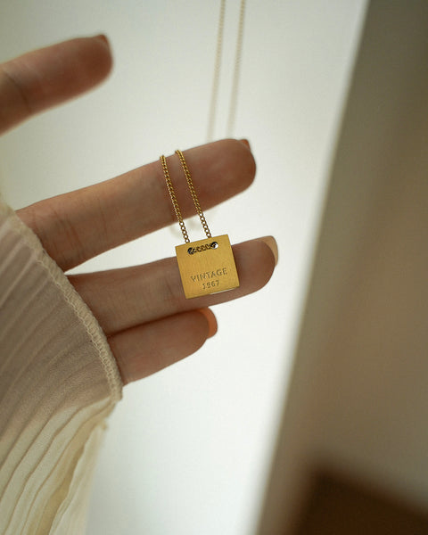 vintage-inspired pendant necklace in brushed matte gold