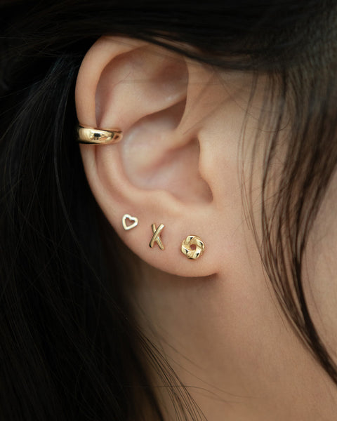 whimsical stud earrings featuring tiny heart cross and pinwheel shapes